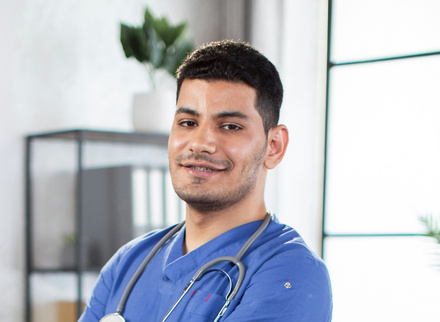 Newly qualified medic male in blue scrubs