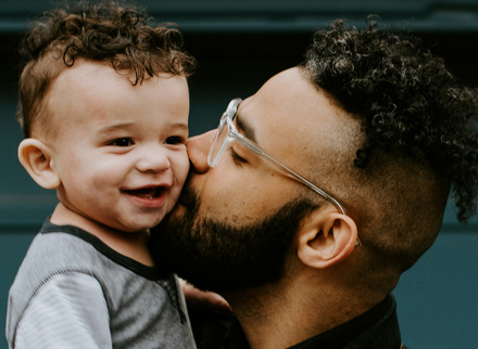 Father kissing son