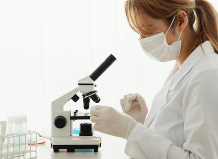 Woman looking into a microscope