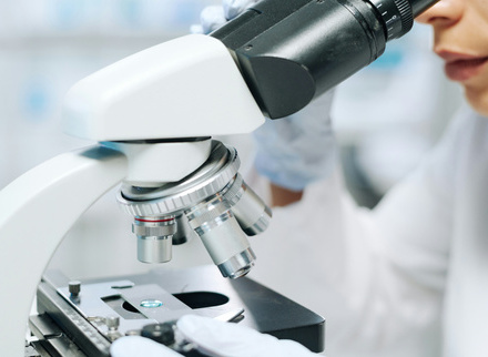 Researcher looking through microscope